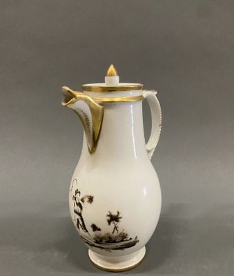 a white and gold coffee pot with a black and white design on it