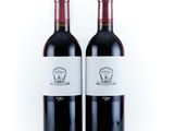 two bottles of red wine sitting next to each other on a white surface