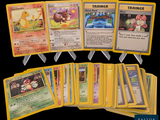 a lot of pokemon cards that are on the table