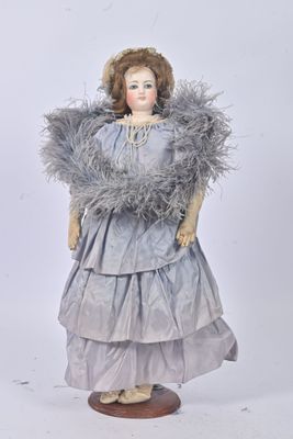 an image of a doll with a feathered dress and a hat