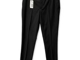the black pants are hanging on a hanger on a white wall