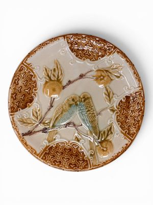 a decorative plate with a bird on it on a white background