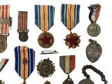 many medals and medals on display on a white background