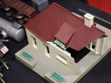 a model of a house with a red roof on a table