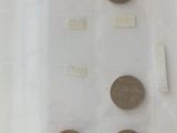 a lot of coins on display in a glass case