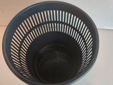 a black plastic bowl that is sitting on a table