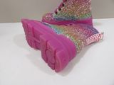 a close up of a pair of pink shoes on a table