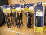many pairs of scissors hanging on a wall in a store