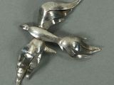 une broche en forme d'oiseau en argent, dotée de deux ailes
