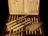 silverware in a wooden case with spoons and forks in it