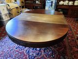 a wooden table with a brown top on a rug