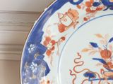 a blue and orange plate with a flower design on it