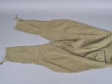 pair of tan pants with fringes on them on a white surface
