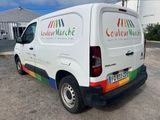 a white van that is parked in a parking lot