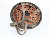 an old rusted helmet on a white surface