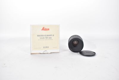 an old camera lens sitting on top of a white table