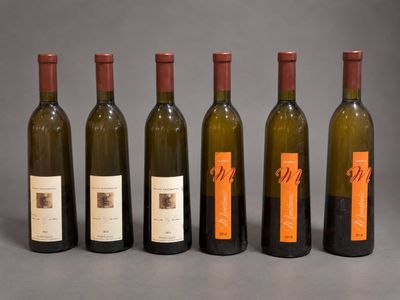 six bottles of wine are lined up in a row