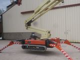a picture of a crane that is parked in front of a building