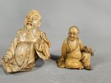 pair of chinese carved ivory figurines of a seated monk and a seated monk