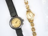 two watches that are sitting next to each other on a table