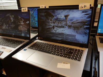 three laptops that are sitting on a desk