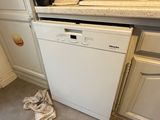 a white dishwasher sitting in the middle of a kitchen