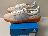 the adidas sneakers are in a box on a table