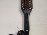 a hair dryer and a hair brush on a table