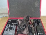 une valise rouge qui contient tout un tas d'objets