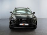 the front view of a black car parked in a showroom