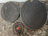 a dirty stove top with two plates and a bowl on it