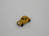 yellow toy car sitting on a white surface in the snow