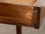 a wooden table with a drawer on top of it