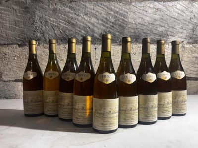 six bottles of wine are lined up in a row on a table
