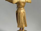 statue of a man holding a sword and a shield on a wooden base