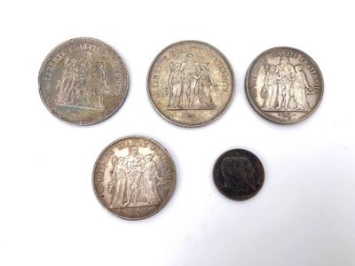 four different types of coins are shown on a white surface
