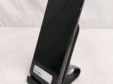 a cell phone on a stand on a white surface