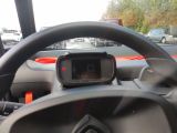 steering wheel of a car with a dash camera on the dashboard