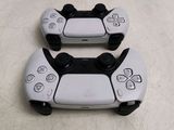 two video game controllers sitting next to each other on a table
