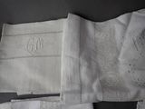 two white handkerchiefs with embroidered monograms on them
