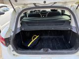 a trunk of a white car with luggage in it