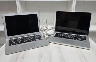 two laptops that are sitting on a table
