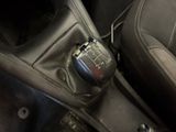 a close up of a car ' s gear lever with a remote control