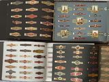 several cigars are lined up in a book on a bed