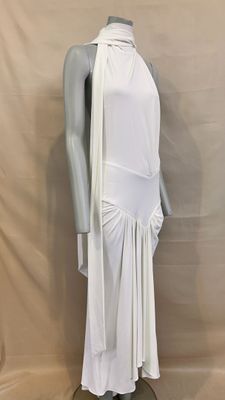 the mannequin is wearing a white dress with a long cape over it