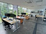 a room with a lot of desks and chairs in it
