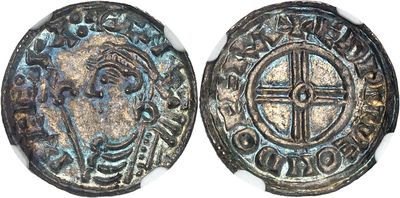 a close up of a coin with a cross on it