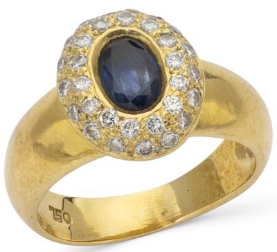 a close up of a gold ring with a sapphire and diamonds