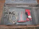 a tool in a metal box on a wooden table