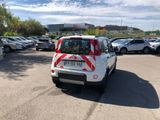 a small white car parked in a parking lot
